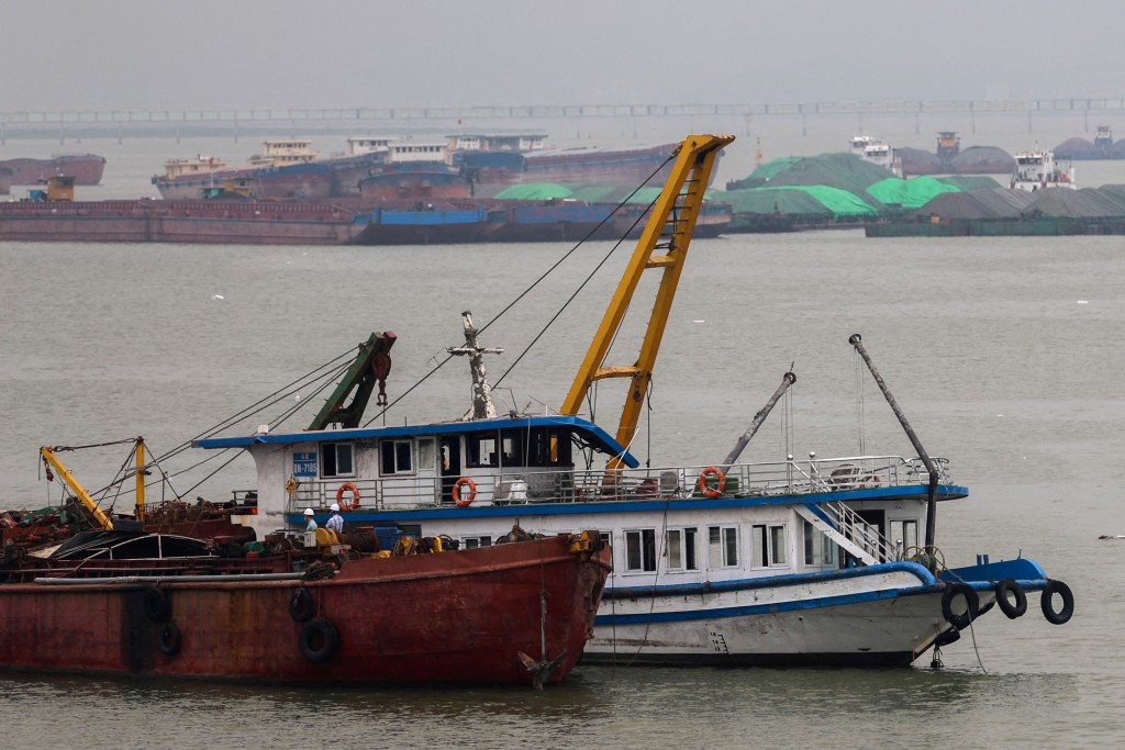 A tourist boat (in white) that capsized in an accident which killed dozens and left several people still missing, is towed back to the port in Halong Bay, Quang Ninh province, Vietnam, July 20, 2025. (Reuters)