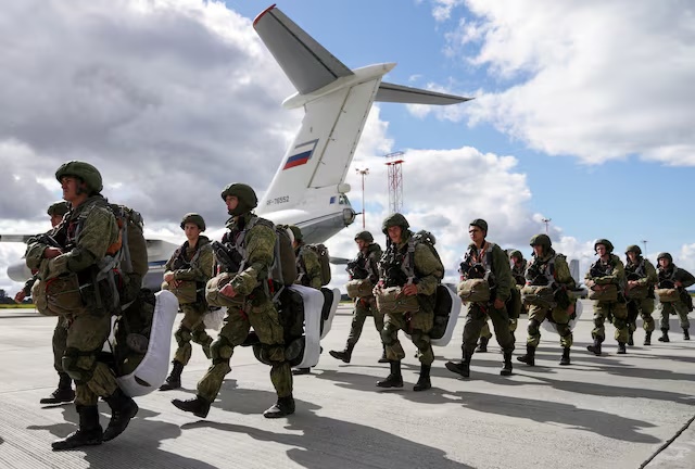 Russian paratroopers walk before boarding Ilyushin Il-76 transport planes as they take part in the military exercises "Zapad-2021" staged by the armed forces of Russia and Belarus at an aerodrome in Kaliningrad Region, Russia, September 13, 2021. REUTERS/Vitaly Nevar/File Photo 