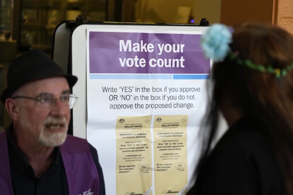A polling place volunteer, left, assists a woman at a polling place in Redfern as Australians cast their final votes in Sydney, Saturday, Oct. 14, 2023, in their first referendum in a generation that aims to tackle Indigenous disadvantage by enshrining in the constitution a new advocacy committee. The prospect of an Indigenous Voice to Parliament has bitterly divided Australia’s Indigenous minority as well as the wider community. (AP Photo/Rick Rycroft) A polling place volunteer, left, assists a woman at a polling place in Redfern as Australians cast their final votes in Sydney, Saturday, Oct. 14, 2023, in their first referendum in a generation that aims to tackle Indigenous disadvantage by enshrining in the constitution a new advocacy committee. The prospect of an Indigenous Voice to Parliament has bitterly divided Australia’s Indigenous minority as well as the wider community. (AP Photo/Rick Rycroft)