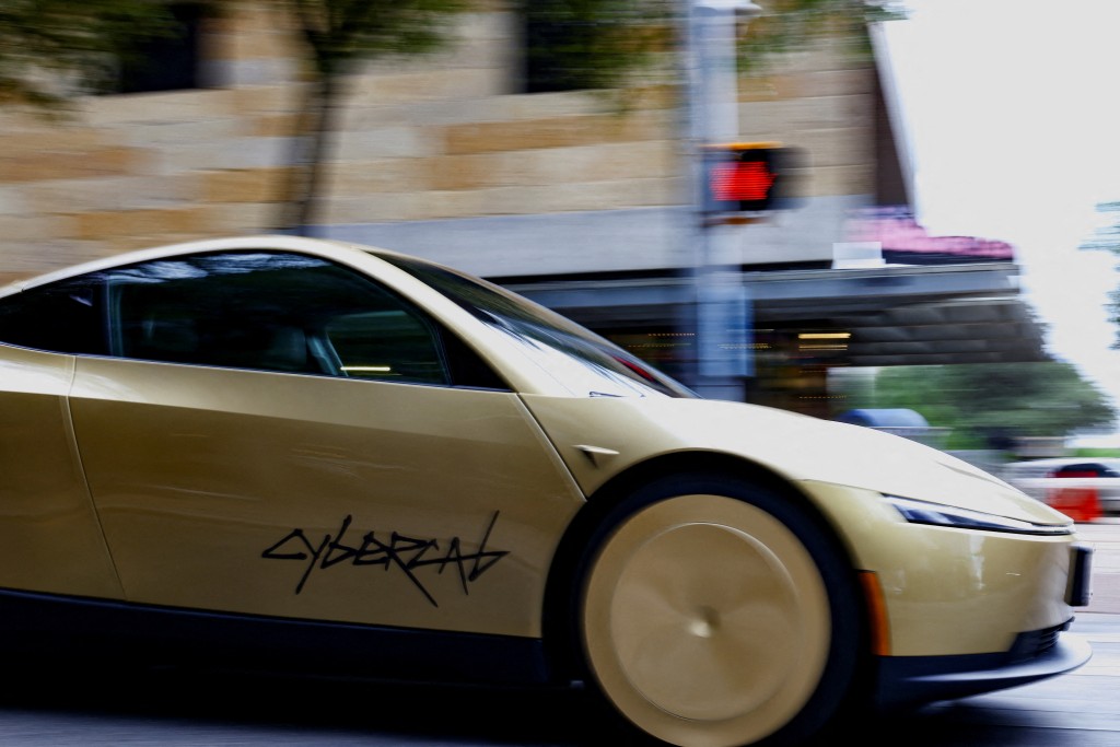 A gold-colored Tesla Cybercab arrives for an event in downtown Austin, Texas, U.S., September 3, 2026. Picture taken with a slow shutter speed. REUTERS
