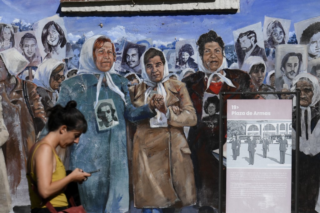 Photo by LUIS ROBAYO / AFP  A mural depicting the Mothers and Grandmothers of Plaza de Mayo is seen on the former Naval Mechanics School building at the former clandestine detention center of the Navy School (ESMA), which operated during the Argentine dictatorship (1976-1983), in Buenos Aires on March 18, 2026.
