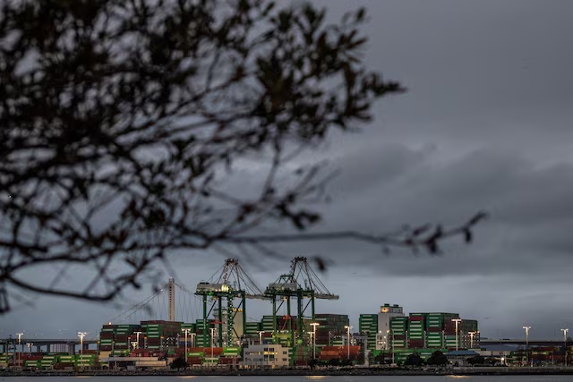 Shipping containers are stacked up at the port of Oakland, in Oakland, California, U.S., February 24, 2026. REUTERS/Carlos Barria