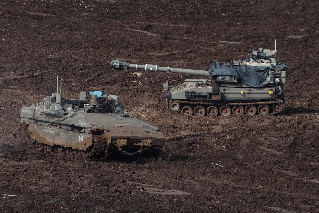 An armoured personnel carrier (APC) and a self-propelled artillery unit at the Israeli side of the border with Lebanon, amid escalation between Iran-backed Hezbollah and Israel, and amid the U.S.-Israeli conflict with Iran, in northern Israel, March 20, 2026. REUTERS/Tyrone Siu