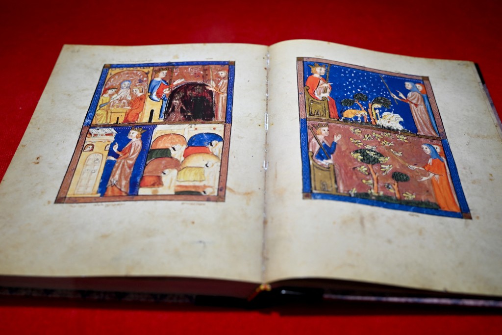 This photograph taken on August 19, 2025 shows the Sarajevo Haggadah manuscript preserved in a display case at Bosnia’s National Museum, in Sarajevo. Bosnia's national museum has defended a decision to donate funds from the display of a precious Jewish manuscript to the people of Gaza. It said ticket sales to see the Sarajevo Haggadah, one of the most precious religious manuscripts of the Middle Ages, would be donated to "support the people of Palestine". (Photo by Elvis BARUKCIC / AFP)