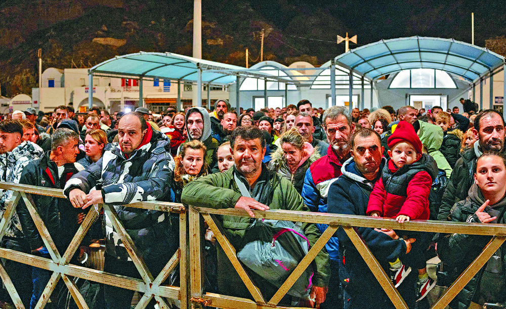 People wait to board a ferry out of Santorini. Reuters People wait to board a ferry out of Santorini. Reuters