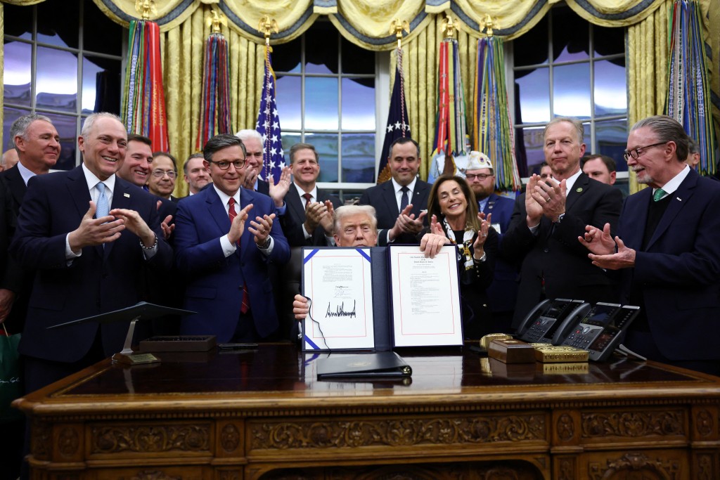 U.S. President Donald Trump poses for a photo after he signs the funding bill to end the U.S. government shutdown, at the White House in Washington, D.C., U.S., November 12, 2025. (Reuters)
