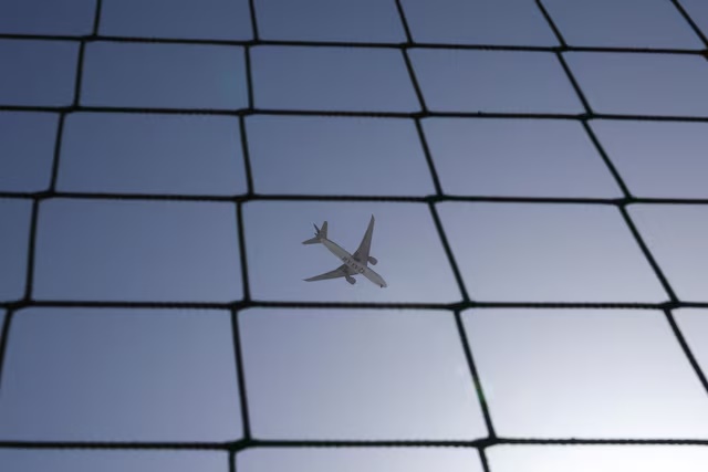 A Qatar Airways plane flies over Dubai, United Arab Emirates, August 20, 2023. REUTERS/Amr Alfiky/File Photo