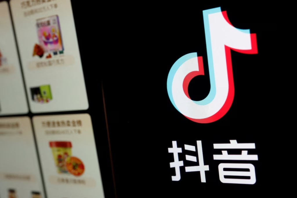 The logo of Douyin is displayed next to a mobile phone displaying an e-commerce site on the app, in this illustration picture taken October 25, 2023. REUTERS