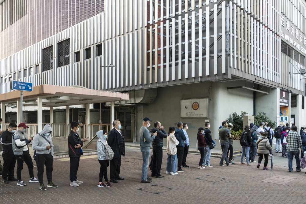 Members of the public wait in line outside a community vaccination center in Hong Kong. (Bloomberg) Members of the public wait in line outside a community vaccination center in Hong Kong. (Bloomberg)