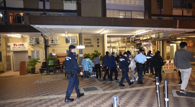 Police officers are spotted securing the area. 