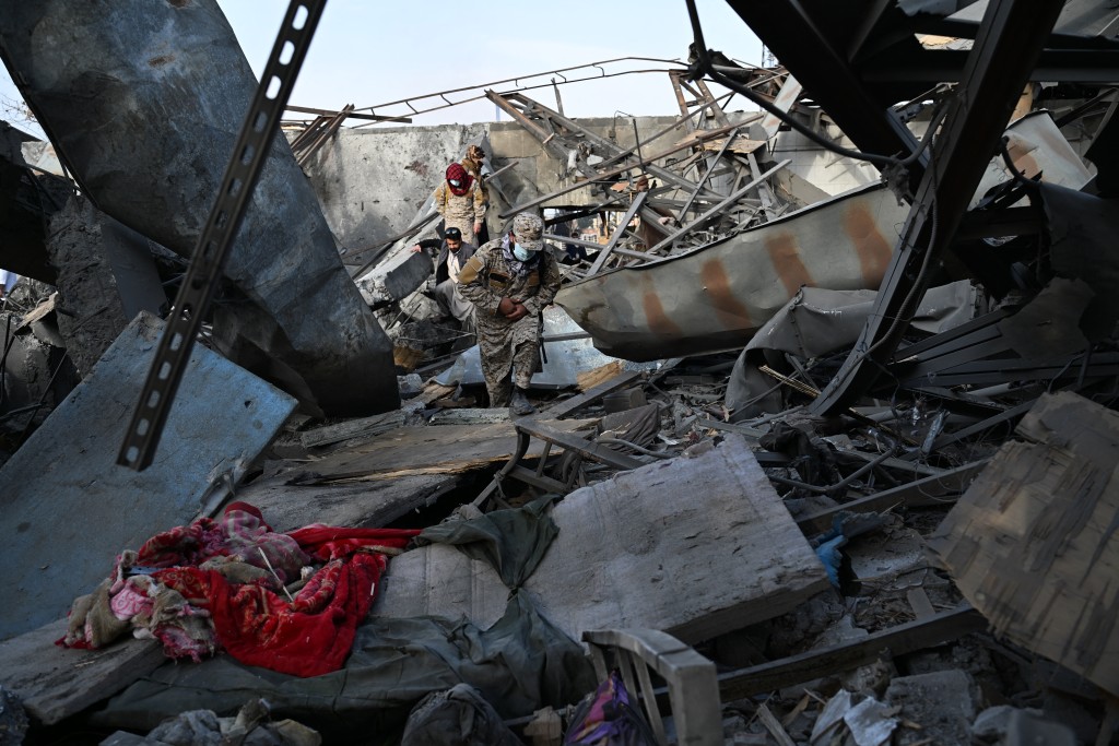 Photo by WAKIL KOHSAR / AFP  Taliban security personnel inspect the site after Pakistani airstrikes hit the Secondary Rehabilitation Services Centre in Kabul on March 17, 2026.