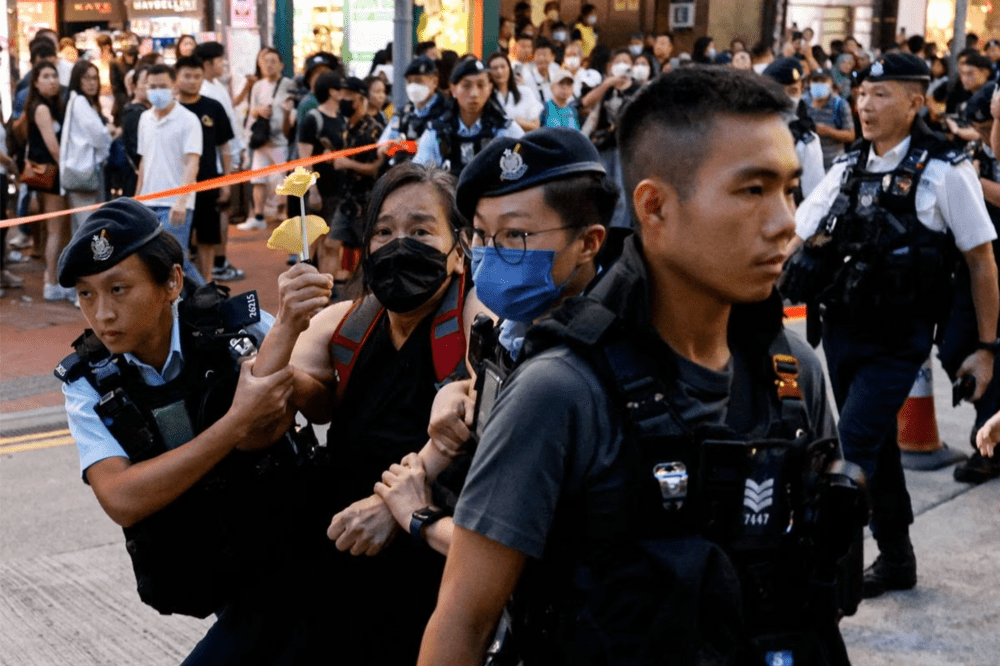 Police detain a woman with paper flowers in downtown on the 34th anniversary of the 1989 Beijing's Tiananmen Square crackdown, near where the candlelight vigil is usually held, in Hong Kong, China June 4, 2023. (REUTERS/Tyrone Siu) Police detain a woman with paper flowers in downtown on the 34th anniversary of the 1989 Beijing's Tiananmen Square crackdown, near where the candlelight vigil is usually held, in Hong Kong, China June 4, 2023. (REUTERS/Tyrone Siu)
