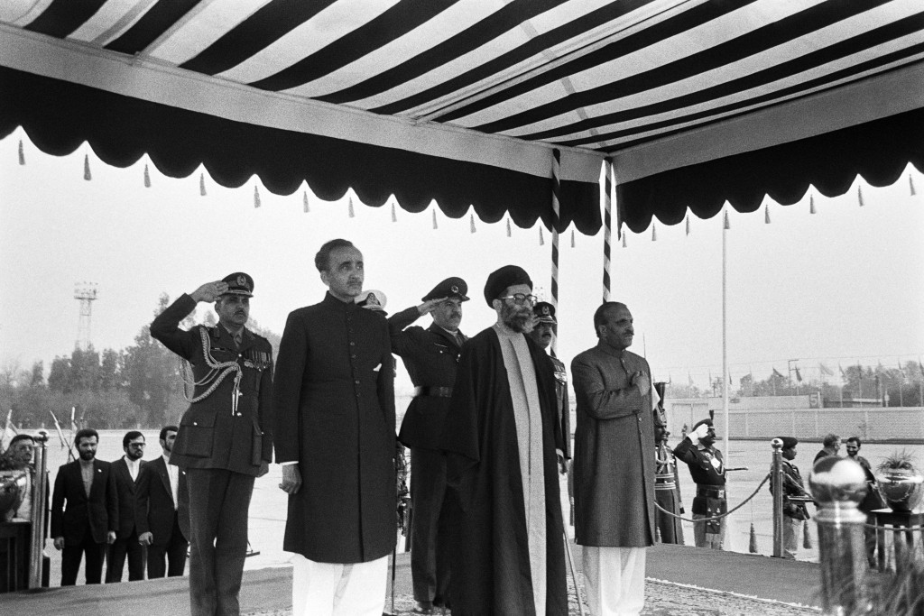 President of the Islamic Republic of Iran Ayatollah Ali Khamenei (C), Pakistani President General Muhammad Zia-ul-Haq (R) and Prime Minister Mohammad Khan Junejo (2nd L), listen to the national anthems on January 13, 1986 upon Khamenei's arrival in Islamabad, Pakistan, where he is to sign an India-Pakistan trade agreement. (AFP)