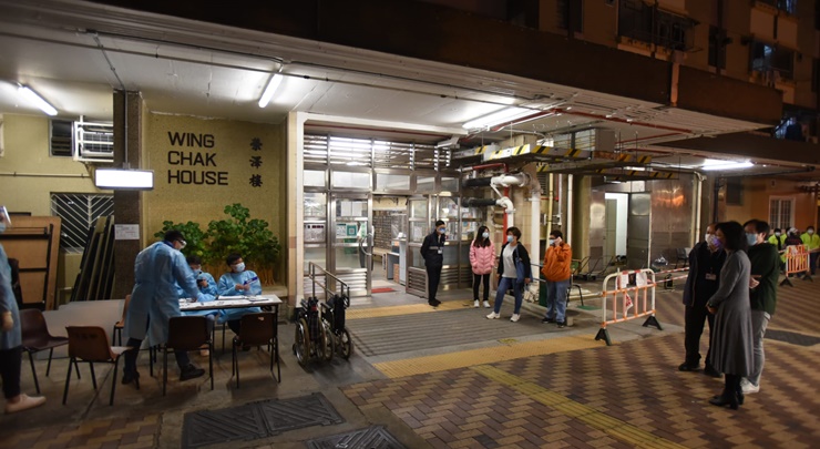 Residents come downstairs to undergo compulsory testing. 