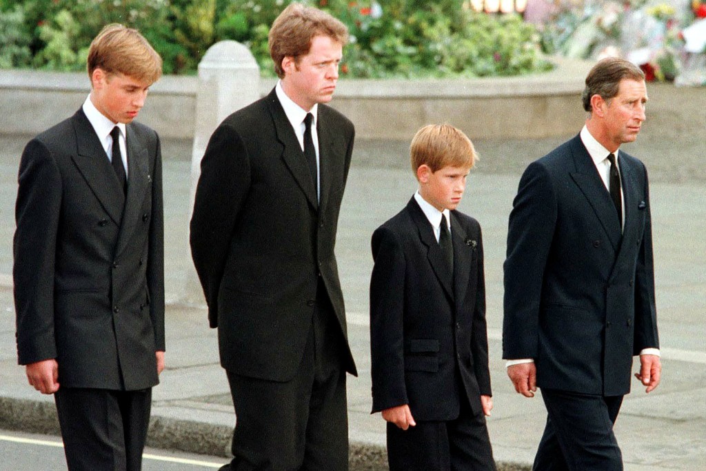 Photo by JEFF J MITCHELL / POOL / AFP Britian's Prince William, Earl Spencer, Prince Harry and then-Prince Charles walk outside Westminster Abbey during the funeral service for Diana, Princess of Wales on September 6, 1997.
