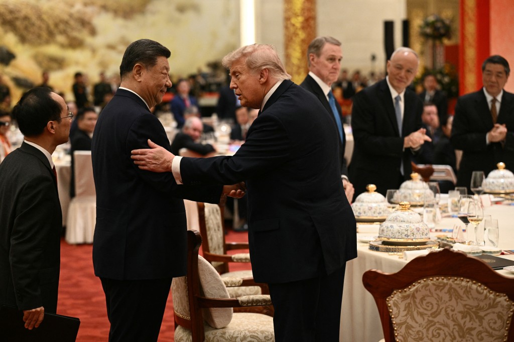 China's President Xi Jinping (2nd L) and US President Donald Trump (C) shake hands as they attend a state banquet at the Great Hall of the People in Beijing on May 14, 2026. (AFP)
