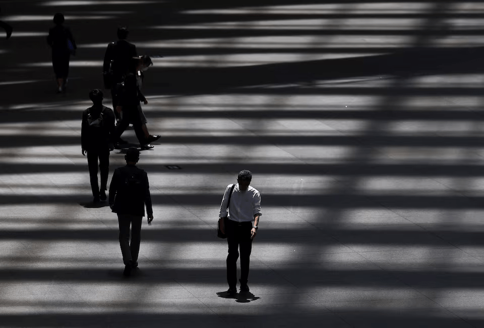 People walk through a convention hall in Tokyo, Japan, May 15, 2025. REUTERS/Issei Kato/File Photo 