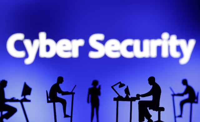 Figurines with computers and smartphones are seen in front of the words "Cyber Security" in this illustration taken, February 19, 2024. REUTERS/Dado Ruvic/Illustration