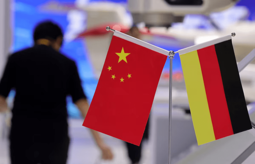 A person walks next to the China and Germany national flags at the 8th China International Import Expo (CIIE) in Shanghai, China, November 5, 2025. REUTERS/Maxim Shemetov/File Photo