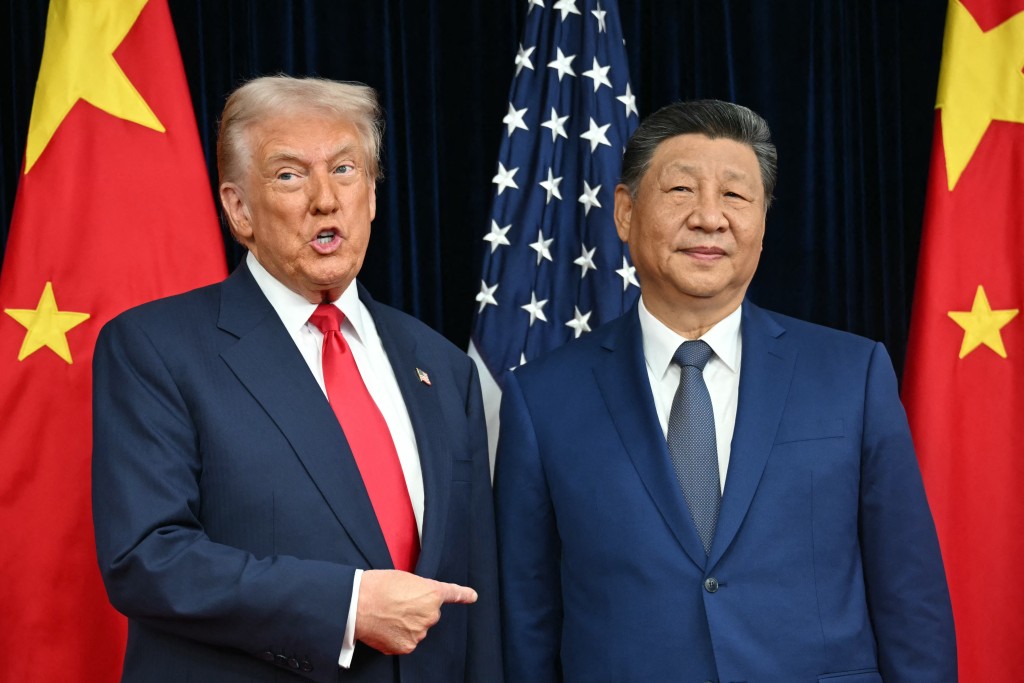 Photo by ANDREW CABALLERO-REYNOLDS / AFP  US President Donald Trump (L) and China's President Xi Jinping greet each other as they arrive for talks at the Gimhae Air Base, located next to the Gimhae International Airport in Busan on October 30, 2025.