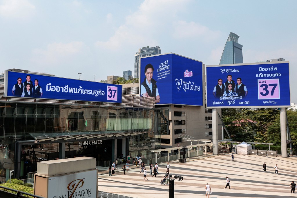 Digital screens display Bhumjaithai Party's election campaign at a shopping mall. Reuters