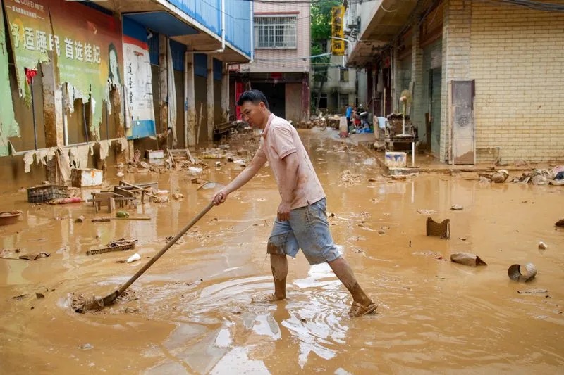A man clears mud after heavy rainfall brought by typhoon Maysak in flooded Sanli town in Guigang, Guangxi Zhuang Autonomous Region, China July 9, 2026. cnsphoto via REUTERS