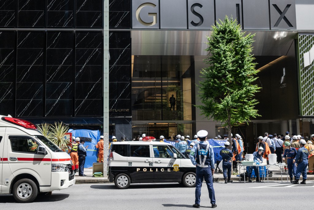 Emergency personnel are seen in front of the Ginza 6 Shopping Center in Tokyo on May 25, 2026, after an individual allegedly sprayed a substance in the area. (AFP)