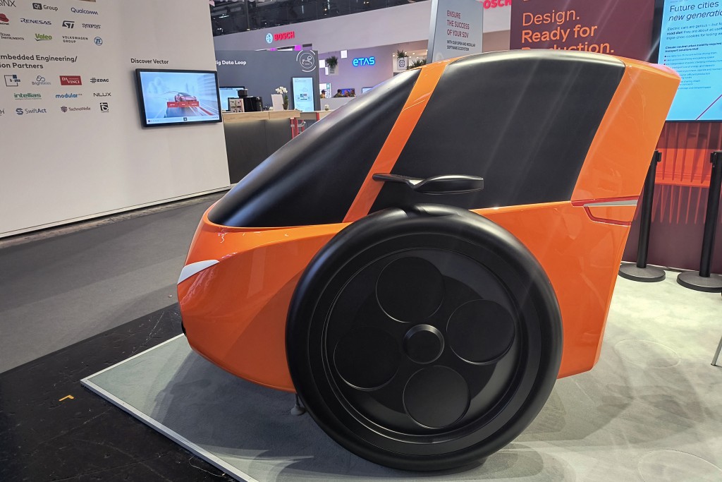 A plastic mock-up of the Wolf etu, a two-wheeled electric concept car that weighs just 450kg and is designed for fun city drives, is pictured at the IAA Mobility International Motor Show (IAA, Internationale Automobil Ausstellung), on September 9, 2025.  (Photo by Louis VAN BOXEL-WOOLF / AFP)