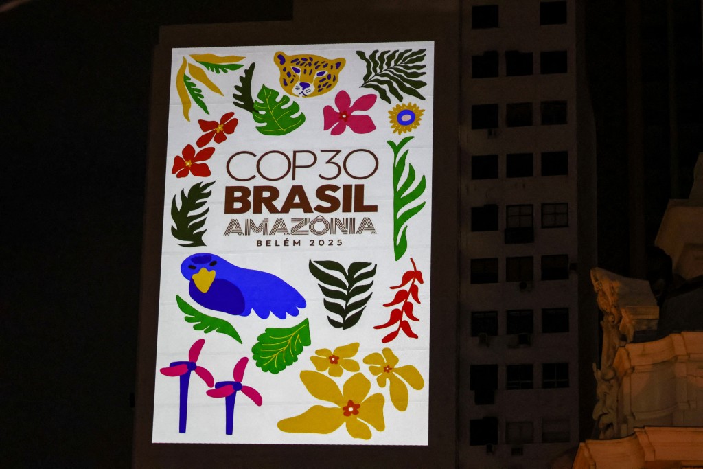Environmental activists project images despicting the COP30 UN climate conference at a building near the Municipal Theater building, demanding action against climate change in Rio de Janeiro, Brazil on November 5, 2025. (Photo by Douglas Shineidr / AFP)
