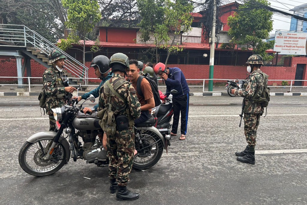 Army personnel inspect identity proofs and documents of commuters along a street as part of security measures imposed in Kathmandu on September 10, 2025. (AFP)
