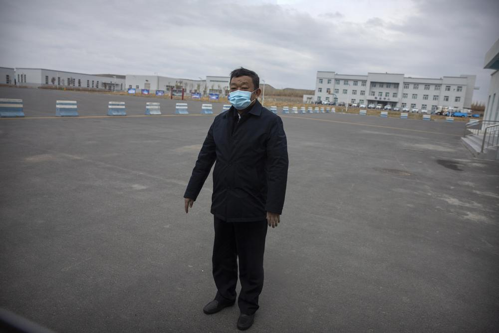 Urumqi Public Security Bureau director Zhao Zhongwei stands in a parking lot outside the inmate detention area at the Urumqi No. 3 Detention Center in Dabancheng in western China's Xinjiang Uyghur Autonomous Region on April 23, 2021.
