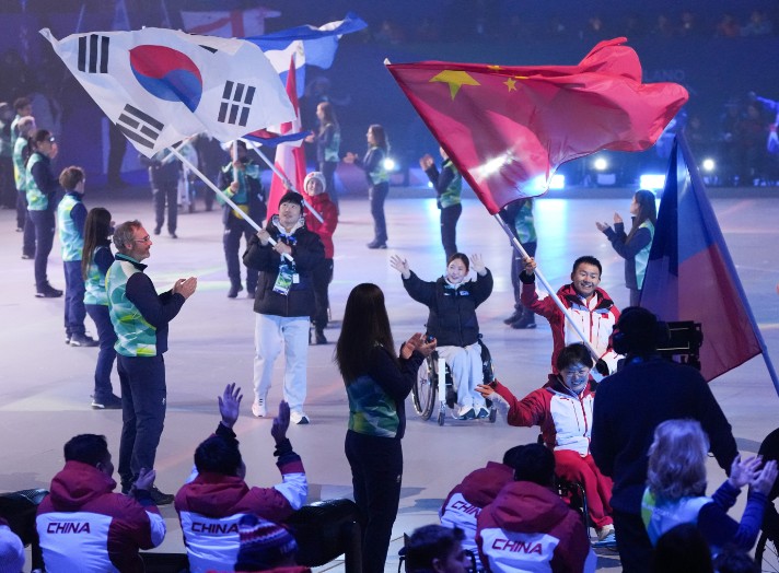 China flagbearers Cai Jiayun and Wang Meng join the parade during the closing ceremony.  XINHUA