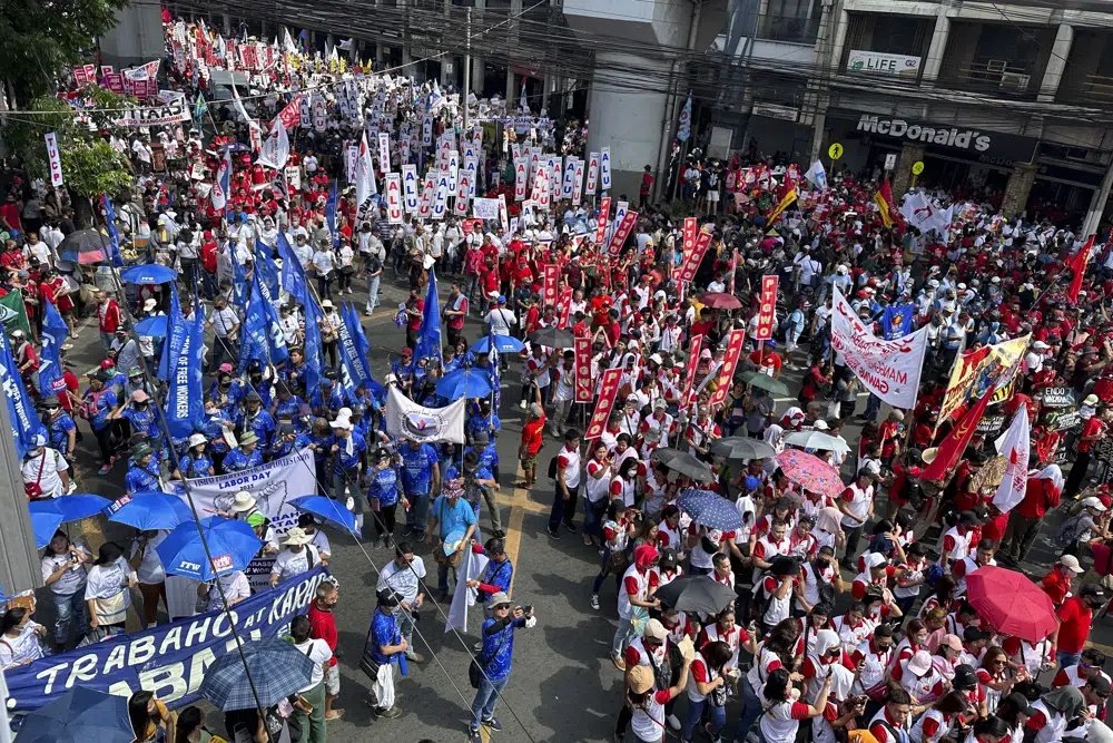 Filipino protesters hold a rally to mark International Labor Day near the Malacanang presidential palace in Manila, Philippines on Monday May 1, 2023. Thousands of Filipino workers marched in the streets of Manila on Monday, reiterating their calls to the government to increase the basic minimum wage, protect jobs in the country. (AP)