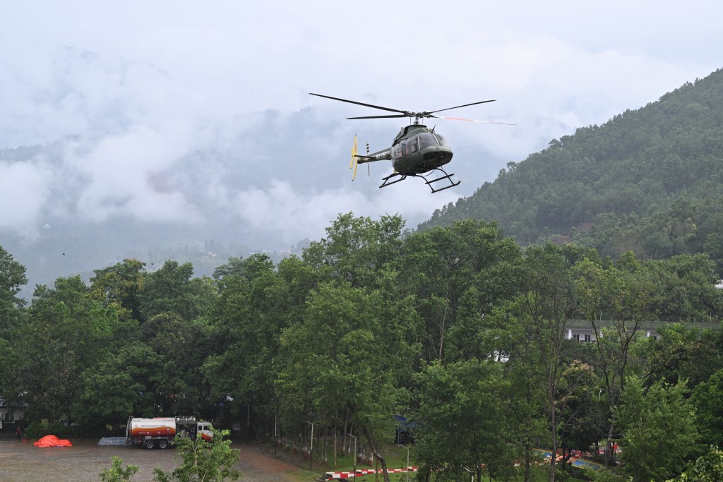Photo by ARUN SANKAR / AFP. A Nepali army helicopter flies relief sorties from Trishuli in Nepal's Nuwakot district on August 29, 2026, after flash floods and landslides hit the Nepal-Tibet border.