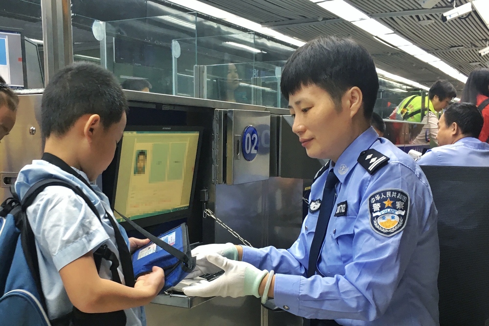 Documents of a boy are checked at Luohu port. Documents of a boy are checked at Luohu port.