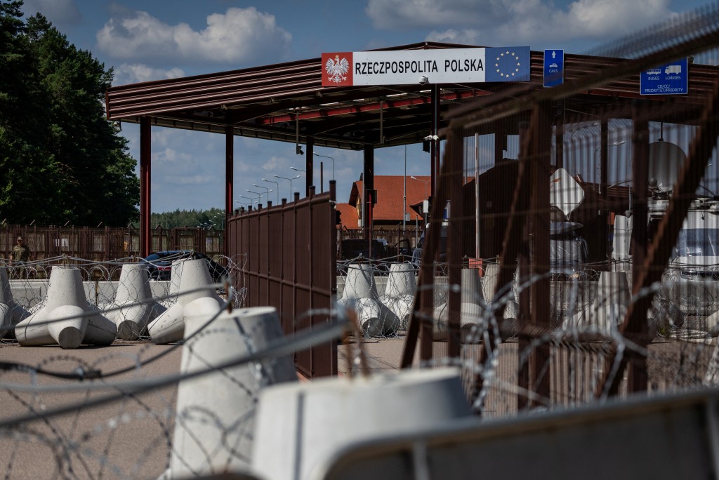A file photo taken on July 21, 2025 shows a sign reading "Republic of Poland" at the border crossing of the Polish-Belarusian country border with barbed wire and a fence in Polowce-Pieszczatka, Poland. (Photo by Wojtek RADWANSKI / AFP)