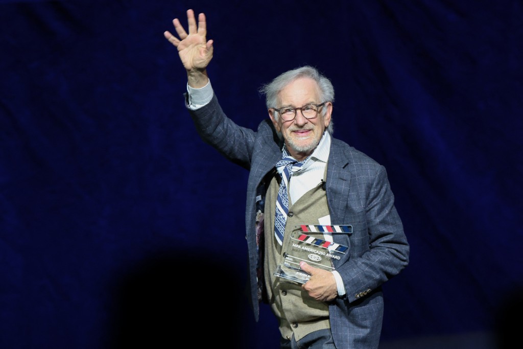 US filmmaker Steven Spielberg waves as he leaves the stage holding the MPA America 250 Award during the Universal Pictures and Focus Features presentation at CinemaCon at The Colosseum at Caesars Palace in Las Vegas, Nevada, on April 15, 2026. (Photo by VALERIE MACON / AFP)