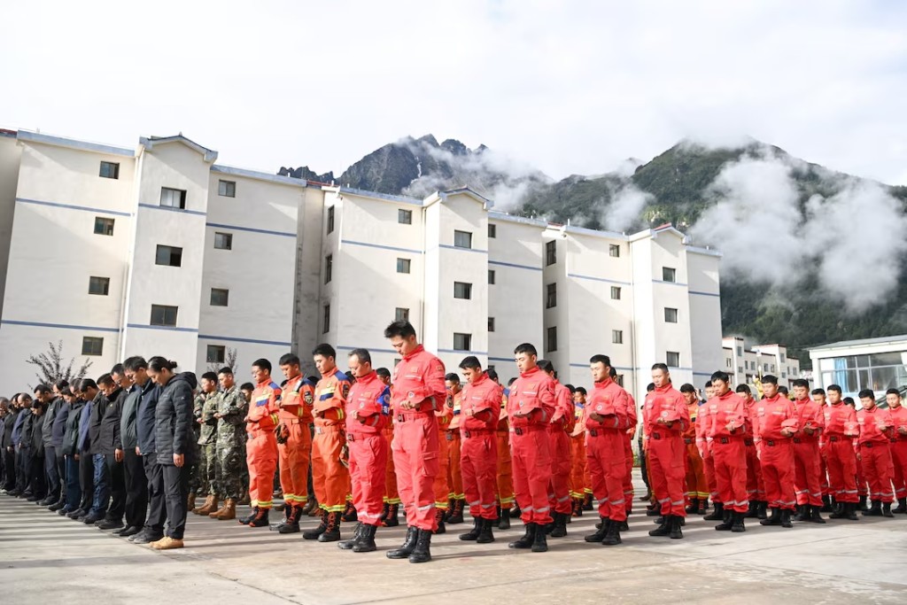 Rescue workers, local officials and residents stand in silence during a memorial service to mourn the victims of the August 26 mudslide, in Gyirong county, Shigatse, Tibet Autonomous Region, China September 1, 2026. cnsphoto via REUTERS