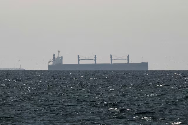 A cargo ship in the Gulf, near the Strait of Hormuz, as seen from northern Ras al-Khaimah, near the border with Oman’s Musandam governance, amid the U.S.-Israeli conflict with Iran, in United Arab Emirates, March 11, 2026. REUTERS/Stringer/File Photo