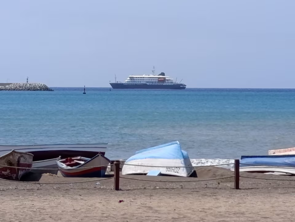 Cruise ship MV Hondius docks off Cape Verde port, as passengers were not allowed off the ship, while health authorities investigated suspected cases of hantavirus aboard the vessel, in Praia Port, Cape Verde, May 4, 2026. REUTERS/Stringer 