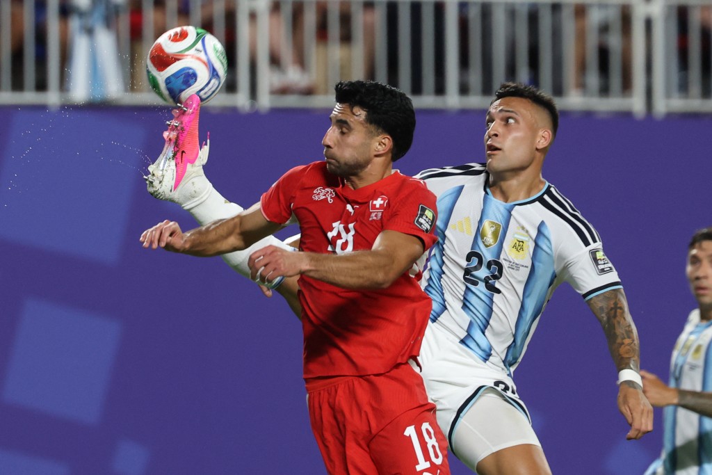Argentina's forward #22 Lautaro Martinez and Switzerland's defender #18 Eray Coemert fight for the ball (AFP)