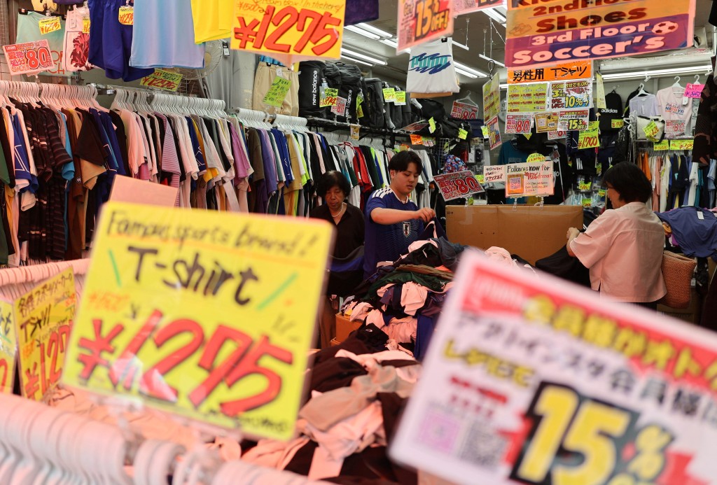 Staff assist customers in checking items at a retail store in Tokyo, Japan, July 27, 2026. REUTERS