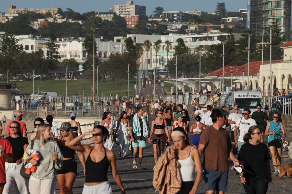 People walk as the crime scene was reopened following the mass shooting at Bondi Beach on Sunday, in Sydney, Australia, December 19, 2025. REUTERS/Hollie Adams/ File Photo 