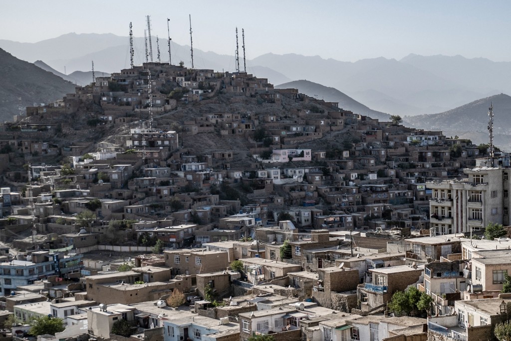 Photo by WAKIL KOHSAR / AFP  In this photograph taken on August 3, 2025, a general view shows residential houses on a hillside in Afghanistan's capital Kabul.