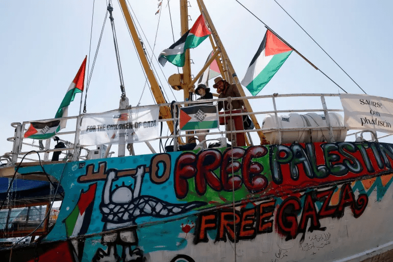 Activists wash the deck of the Freedom Flotilla Coalition ship 'Handala' as they prepare to sail for Gaza [File: Reuters]