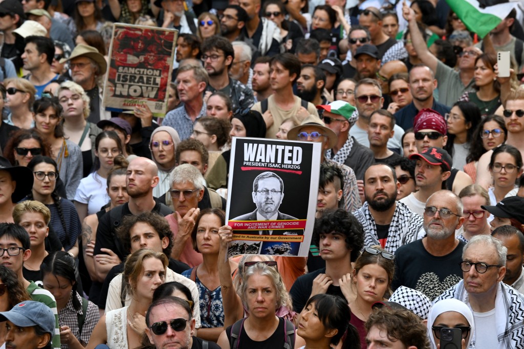 Pro-Palestinian protesters take part in a demonstration against Israeli President Isaac Herzog's visit to Australia in Sydney on February 9, 2026. (Photo by Saeed KHAN / AFP)