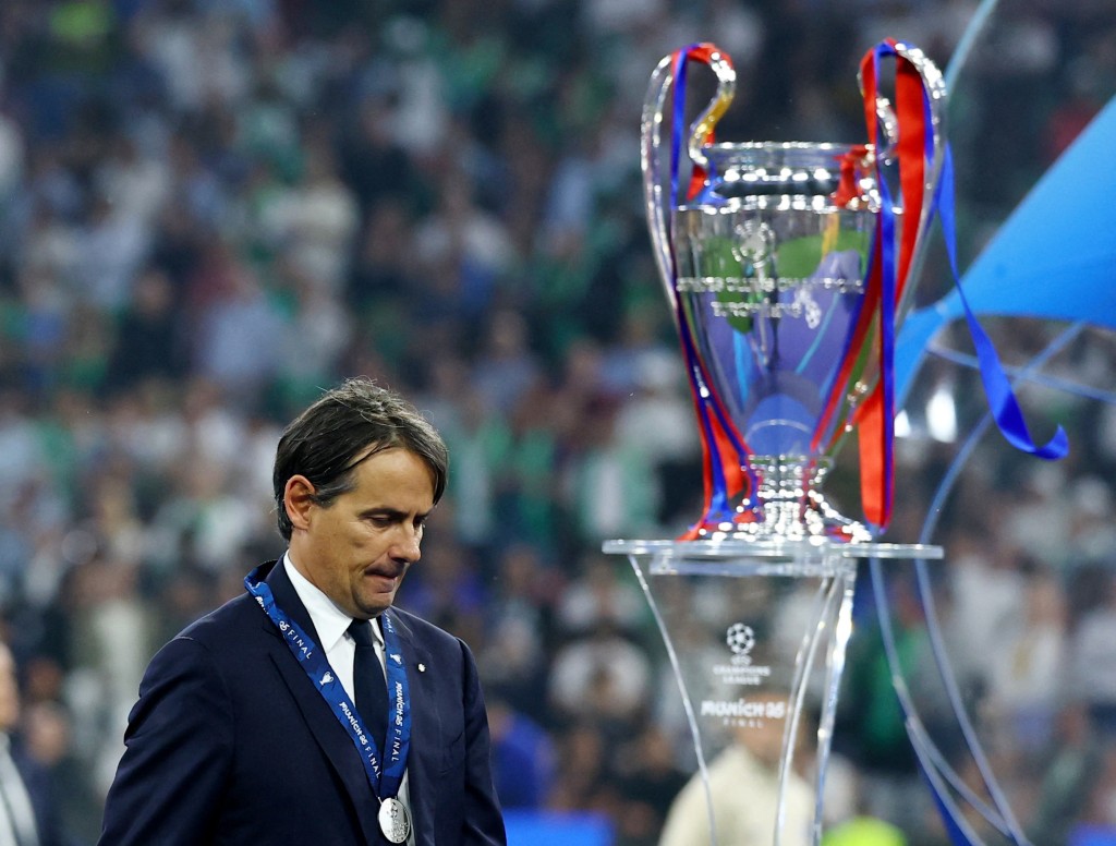 Inter Milan coach Simone Inzaghi looks dejected as he walks past the Champions League trophy after collecting his runners up medal. (Reuters)