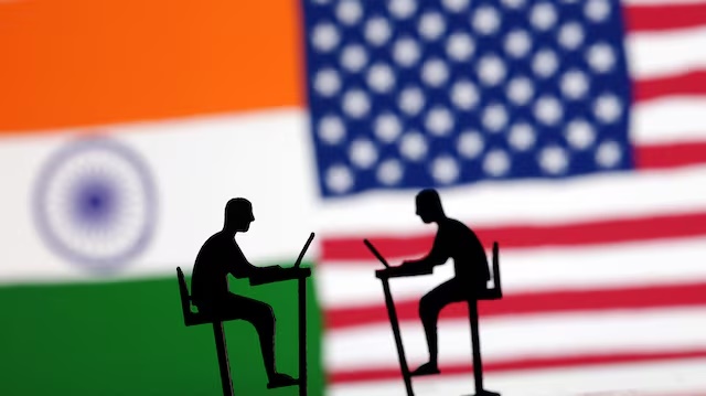 The Indian flag, the U.S. flag and people miniatures with laptops are seen in this illustration taken March 10, 2024. REUTERS/Dado Ruvic/Illustration