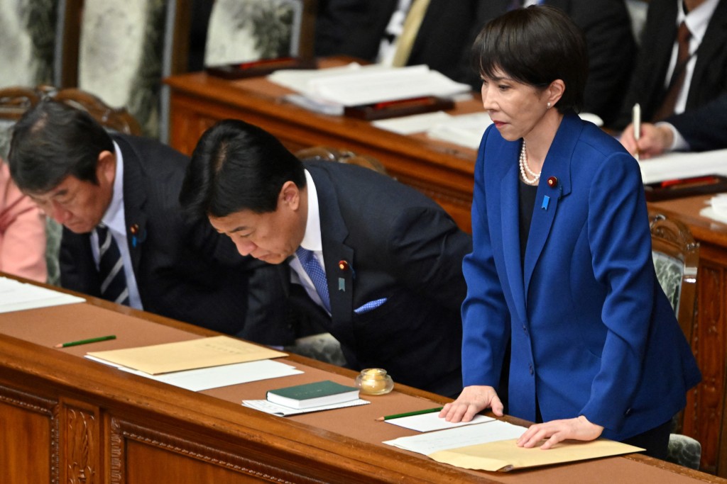 Photo by KAZUHIRO NOGI / AFP. Japan's Prime Minister Sanae Takaichi (R) leaves after delivering her policy speech in the House of Representatives plenary session in Tokyo on October 24, 2025.