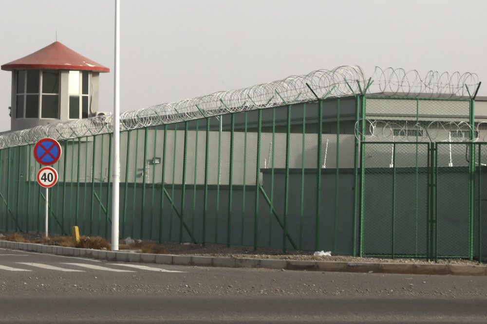 In this Monday, December 3, 2018, file photo, a guard tower and barbed wire fence surround a detention facility in the Kunshan Industrial Park in Artux in western China's Xinjiang region. In this Monday, December 3, 2018, file photo, a guard tower and barbed wire fence surround a detention facility in the Kunshan Industrial Park in Artux in western China's Xinjiang region.